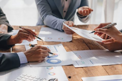 Team of lawyers and tax auditors brainstorming together and calc